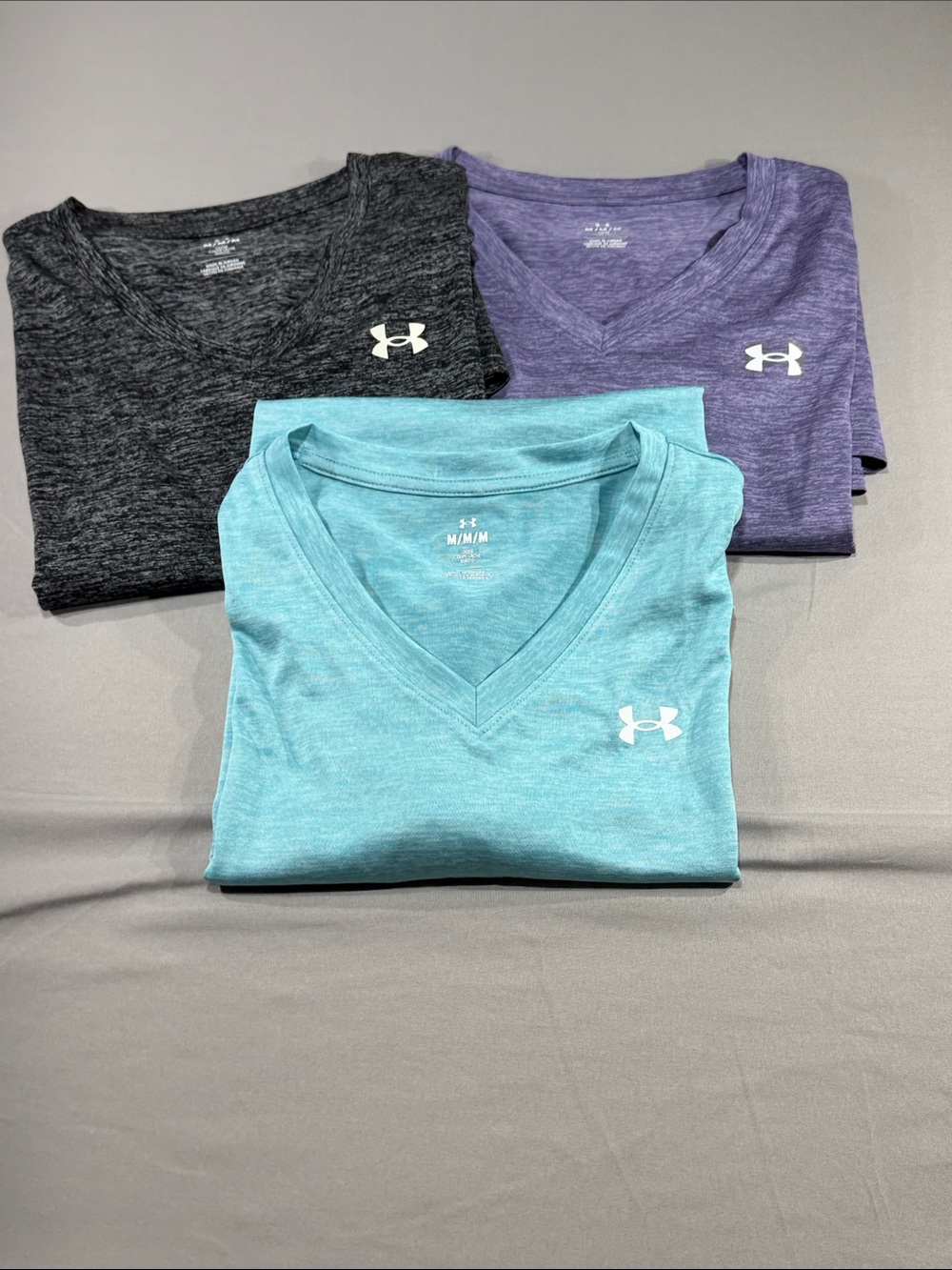 3 Under Armour Women’s V-neck performance
Polos, Charcoal gray, Purple & Aqua.